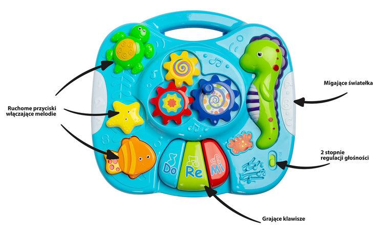 Falla interactive Toyz table, which will provide a lot of fun for little ones. The table top is equipped with a mini piano with DO RE MI keys, 3 buttons (each works differently) that turn on different melodies and a knob with gears. Vivid colors attract attention and encourage fun. The table has a 2-stage volume control. Falla allows you to detach the legs and, thanks to special straps, attach it to a cot or attach it to a bow in a pram.