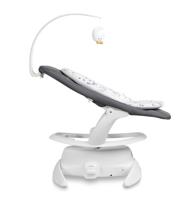 An electric baby rocker Noco featuring a bar and melodies, designed for babies and infants. The rocker have a graphite seat with a patterned fabric, white frame, and a variety of controls and accessories, such as a safety bar and sensory toy.