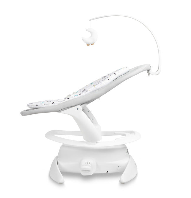 An electric baby rocker Noco featuring a bar and melodies, designed for babies and infants. The rocker have a graphite seat with a patterned fabric, white frame, and a variety of controls and accessories, such as a safety bar and sensory toy.