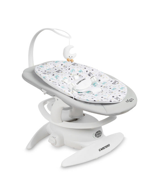 An electric baby rocker Noco featuring a bar and melodies, designed for babies and infants. The rocker have a graphite seat with a patterned fabric, white frame, and a variety of controls and accessories, such as a safety bar and sensory toy.