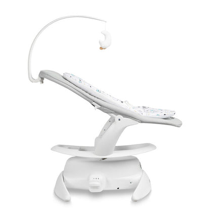 An electric baby rocker Noco featuring a bar and melodies, designed for babies and infants. The rocker have a graphite seat with a patterned fabric, white frame, and a variety of controls and accessories, such as a safety bar and sensory toy.