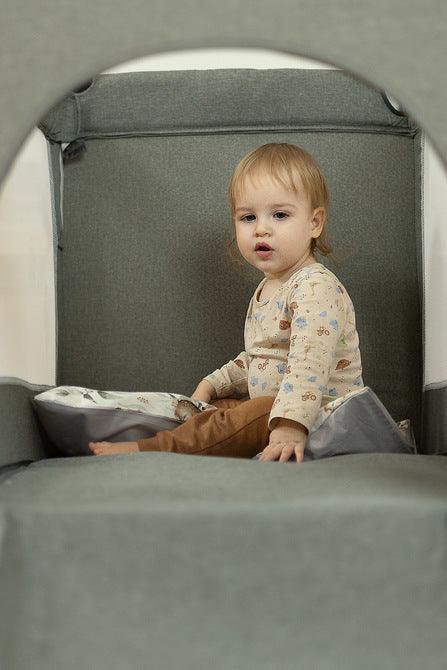 The Esti cot is a travel cot designed to facilitate the care of babies. Its biggest advantage is the foldable side, which transforms the cot into an extra bed and provides more comfortable access to the child. The practical folding mechanism means that folding or unfolding takes only a moment. The cot also has wheels with a blockade for easy portability. The side door closed with a zipper will allow older children to safely enter the cot, which can be used as a playpen.