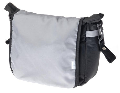 A capacious and solid mama bag made of safe materials. Multiple compartments, pockets and rubber bands help in organizing all accessories necessary during a stroll with your baby. The velcro-closed flap allows quick and easy access to the most important items. The included shoulder strap can be snapped onto the strollers handle for even more convenience.