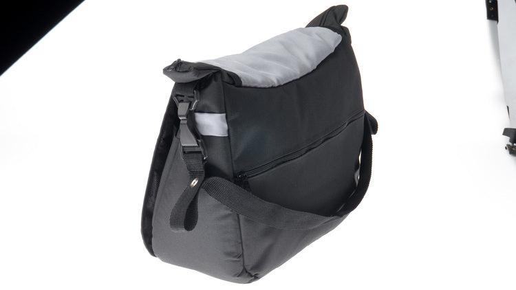 A capacious and solid mama bag made of safe materials. Multiple compartments, pockets and rubber bands help in organizing all accessories necessary during a stroll with your baby. The velcro-closed flap allows quick and easy access to the most important items. The included shoulder strap can be snapped onto the strollers handle for even more convenience.