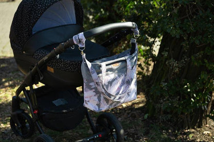 The Velvet stroller bag will meet the requirements of an active mother, it is roomy and fits modern prams. Made of excellent materials with the utmost attention to detail. The spacious interior will allow you to fit all the accessories necessary during a walk. In the middle it has a compartment that helps to organize accessories so that they can be easily found and 2 pockets. Equipped with shoulder straps, one long strap and two handles that allow you to attach the bag to the handle of the trolley.