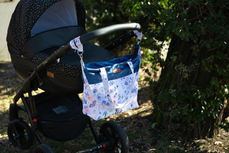 The Velvet stroller bag will meet the requirements of an active mother, it is roomy and fits modern prams. Made of excellent materials with the utmost attention to detail. The spacious interior will allow you to fit all the accessories necessary during a walk. In the middle it has a compartment that helps to organize accessories so that they can be easily found and 2 pockets. Equipped with shoulder straps, one long strap and two handles that allow you to attach the bag to the handle of the trolley.