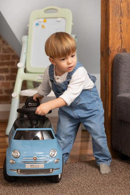 The Fiat 500 children's ride-on car from Toyz combines the charm of Italian design with high-quality workmanship. It will help in learning to move independently and will be a lot of fun while having fun. The vehicle has a realistic steering wheel with two buttons that make sounds. There is a toy compartment under the seat.