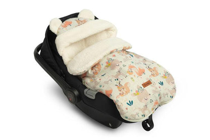 The romper bag is designed for the smallest children, with charming ear details on the hood. It features a high-quality waterproof outer layer with a beautiful pattern. Inside, there's a fluffy silicone non-woven fabric for added cold protection, and a delicate plush inner layer for warmth. The romper bag has two zippers for easy access from both sides and the front. It's equipped with holes for 3-point seat belts and can be used in car seats, prams, and even sleds. Suitable for children aged 0-18 months.