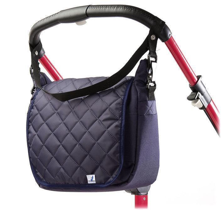 Quiltet top flap and sleek shape make this unique mama bag look extremely fashionable and fancy. It will be a great feature on the strollers handles or on the mothers shoulder. A smart system of pockets and separators allows a quick access to any accessories stored inside.